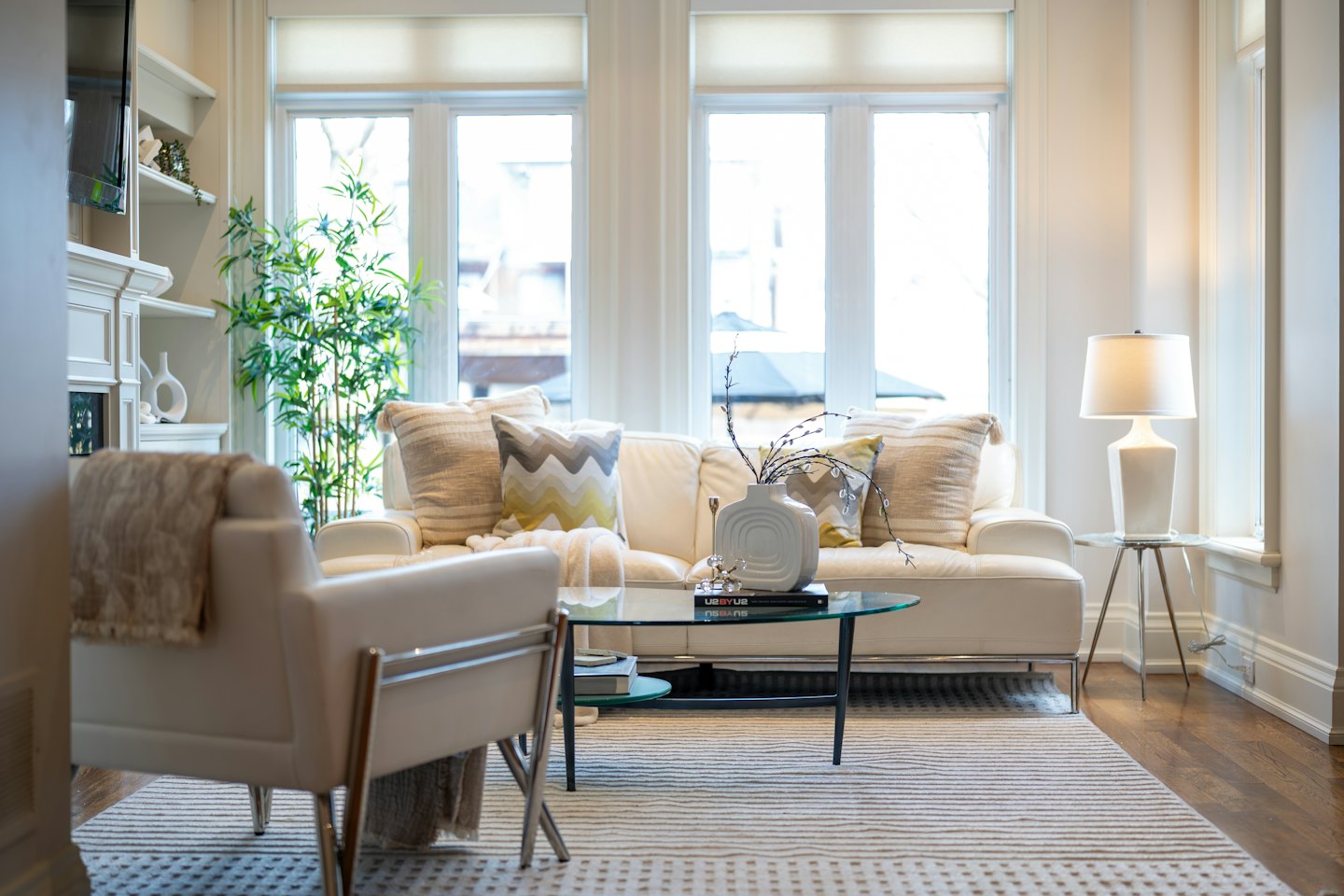 Modern living room with cream sofa and glass coffee table.